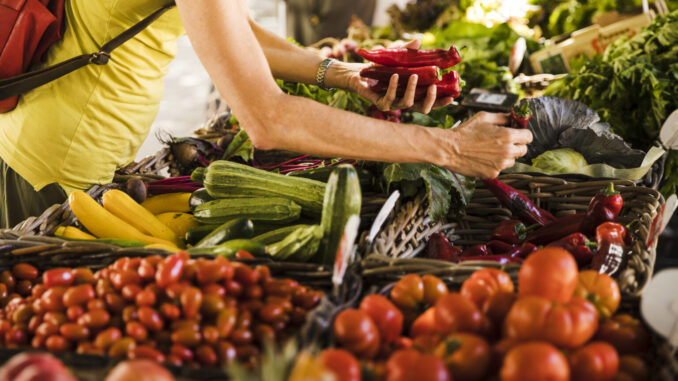 man-choosing-vegetable-from-vegetable-stall-supermarket-1536x1024